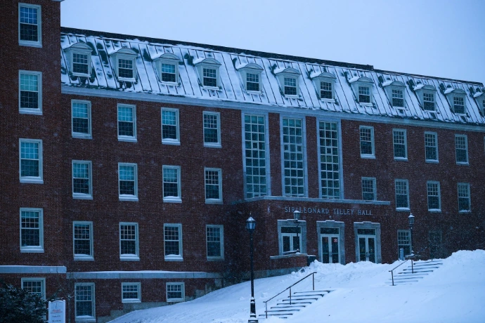 A building with a lot of windows and snow on the ground